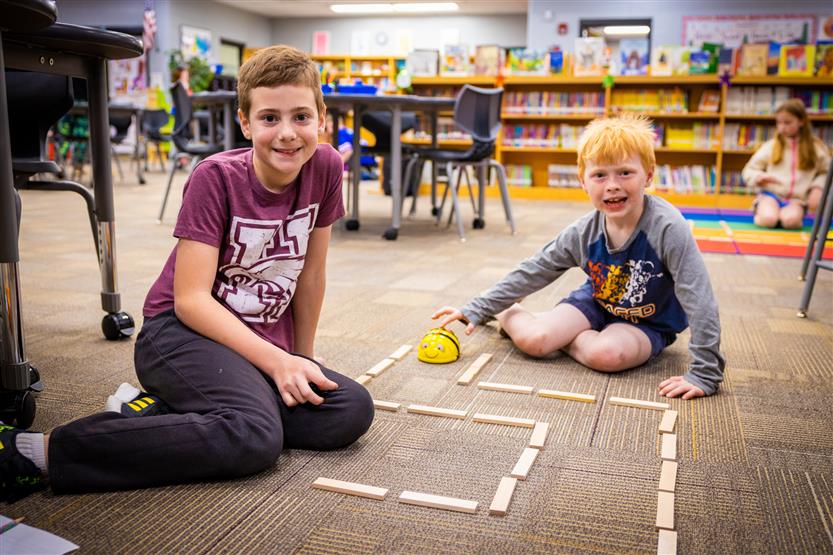 Students use Bee-Bots in the Learning Commons